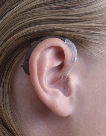 image of a person wearing a behind the ear hearing aid